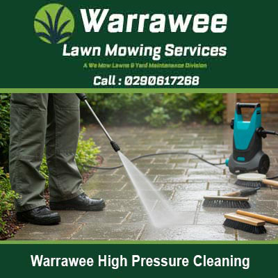 Worker pressure washing a paved surface in Warrawee
