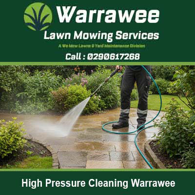 Worker pressure washing a paved patio in Warrawee