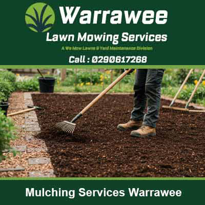 Worker using rake to spread fresh dark mulch in Warrawee
