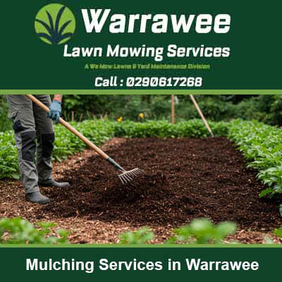 Worker raking fresh mulch around plants in Warrawee
