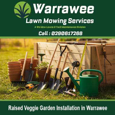 Gardening tools near wooden raised garden in Warrawee